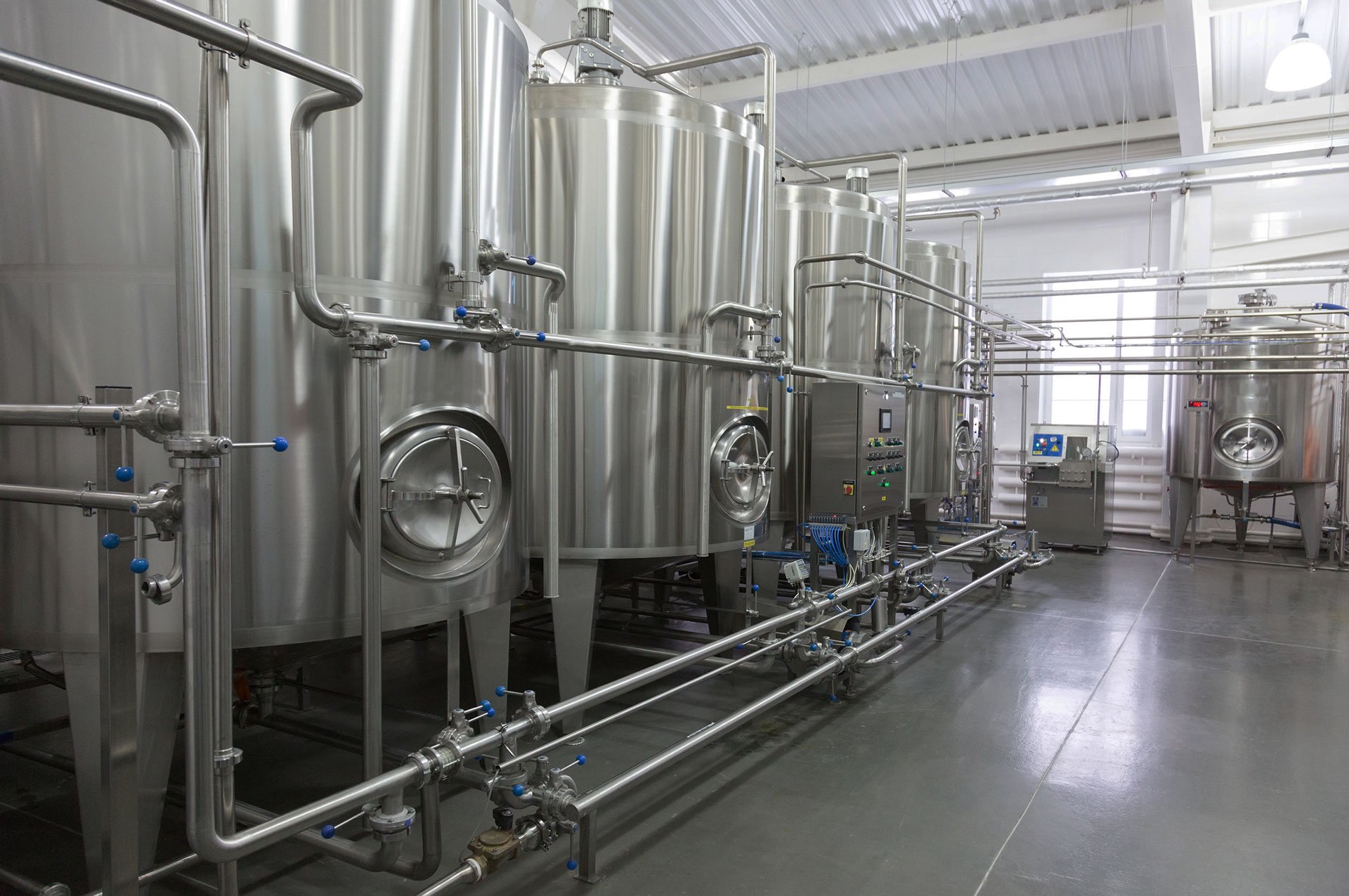 Stainless steel process piping and tanks in an industrial facility